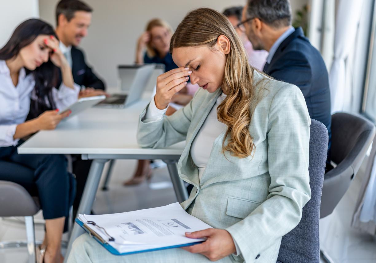 Stressed professional in meeting